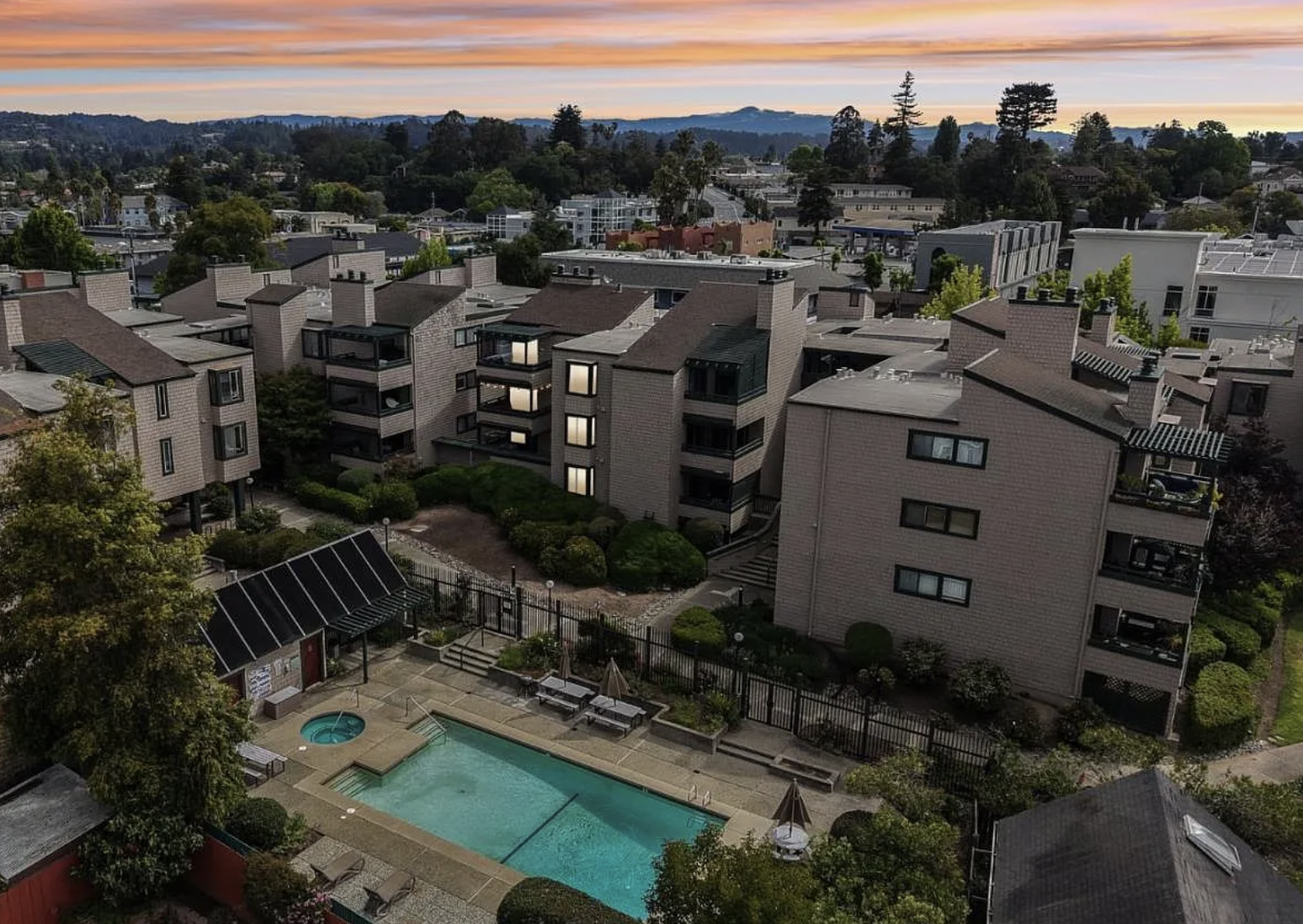 Aerial view of the 321 Broadway residences at sunset with pool and courtyard